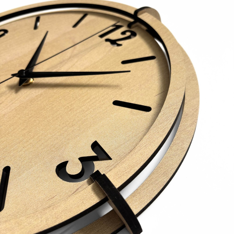 Ceas de perete modern din lemn, cu cifre 3D din plastic și o ramă distinctivă, într-un decor natural.